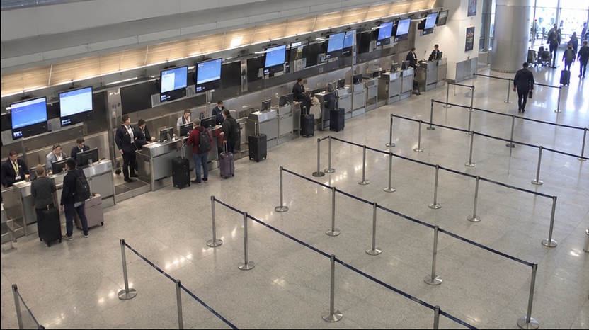High-angle airport camera view showing uneven utilization across service lanes