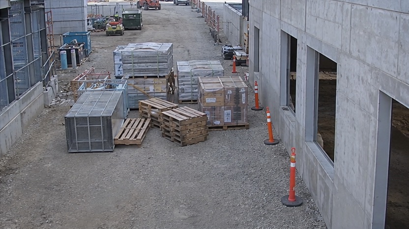 Elevated site camera view showing materials obstructing an access route