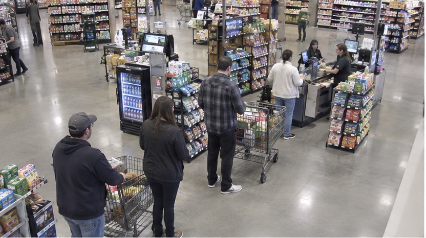 High-angle checkout view showing a retail queue