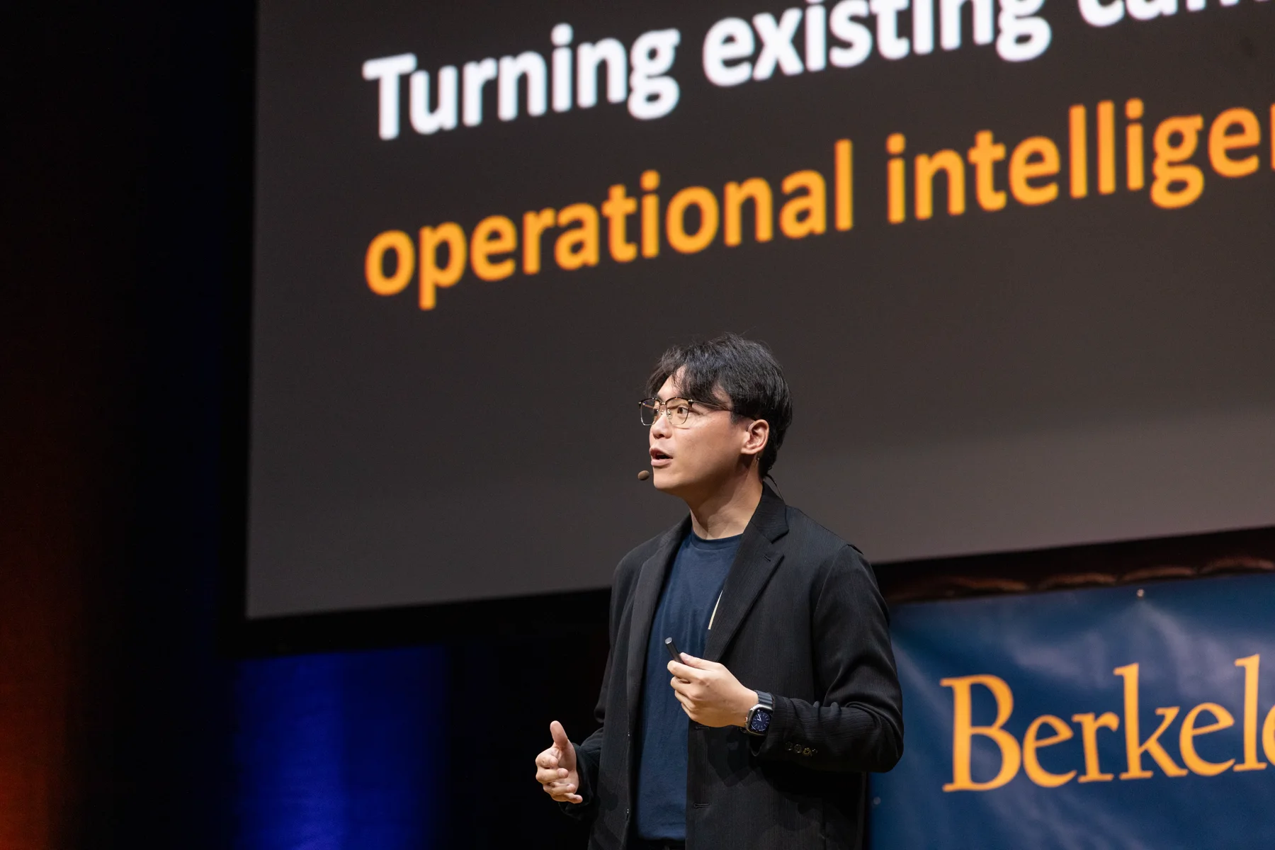 Andrew Chen presenting Fortune AI on stage at Berkeley SkyDeck Demo Day